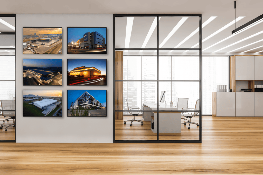 A corporate office wall displaying a grid of six Block Mounted photos of modern buildings and landscapes, showcasing a professional photo block mounting display for corporate interiors.
